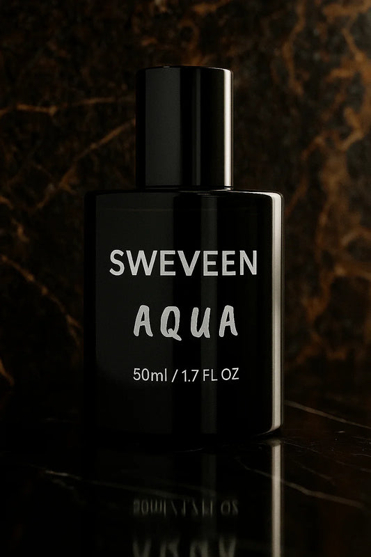 Black perfume bottle with silver lettering and reflection.