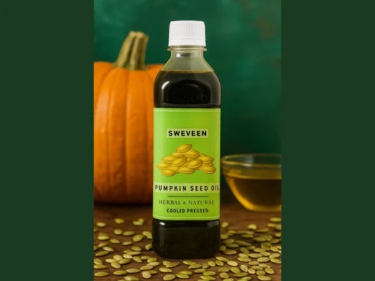Bottle of pumpkin seed oil with green label, pumpkin, and seeds.
