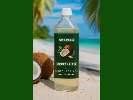 A bottle of coconut oil on a beach next to a halved coconut.