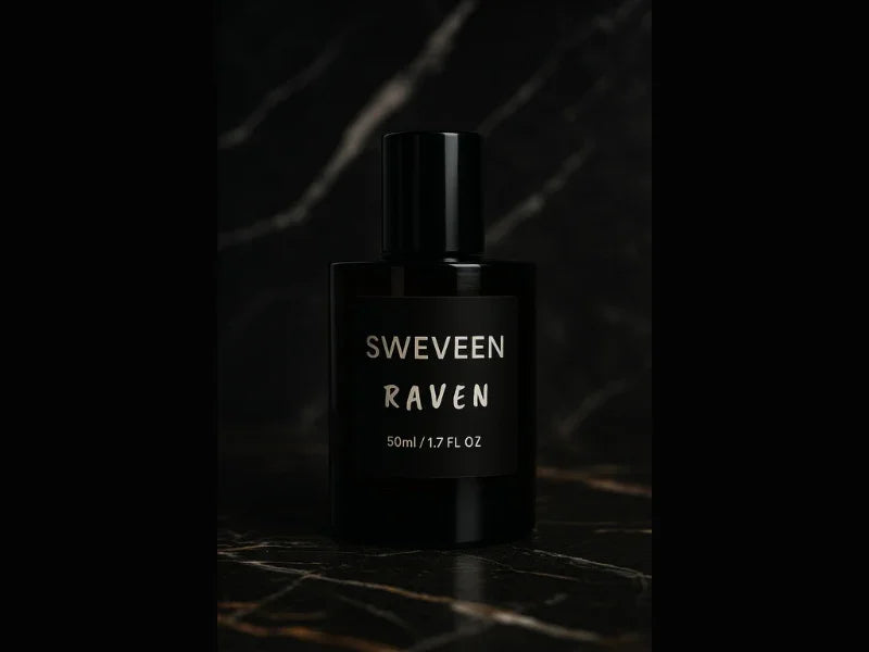Black perfume bottle with a label that reads "SWEVEEN RAVEN 50ml / 1.7 FL OZ" on a dark marble surface.
