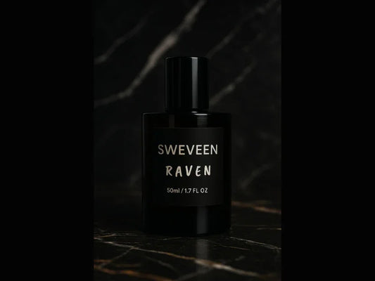 Black perfume bottle with a label that reads "SWEVEEN RAVEN 50ml / 1.7 FL OZ" on a dark marble surface.
