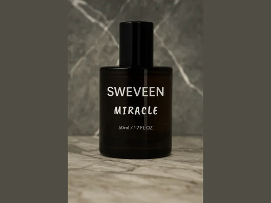 A brown cylindrical perfume bottle with a black cap, labeled "SWEVEEN MIRACLE".