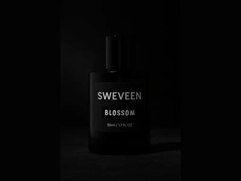 Black perfume bottle with "SWEVEEN BLOSSOM" label.
