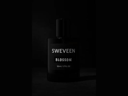 Black perfume bottle with "SWEVEEN BLOSSOM" label.
