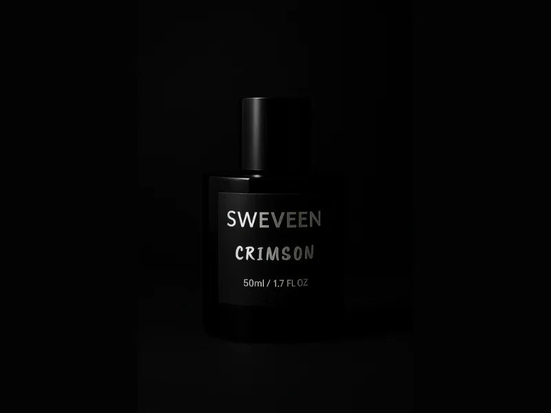 Black perfume bottle with silver text on a black background.